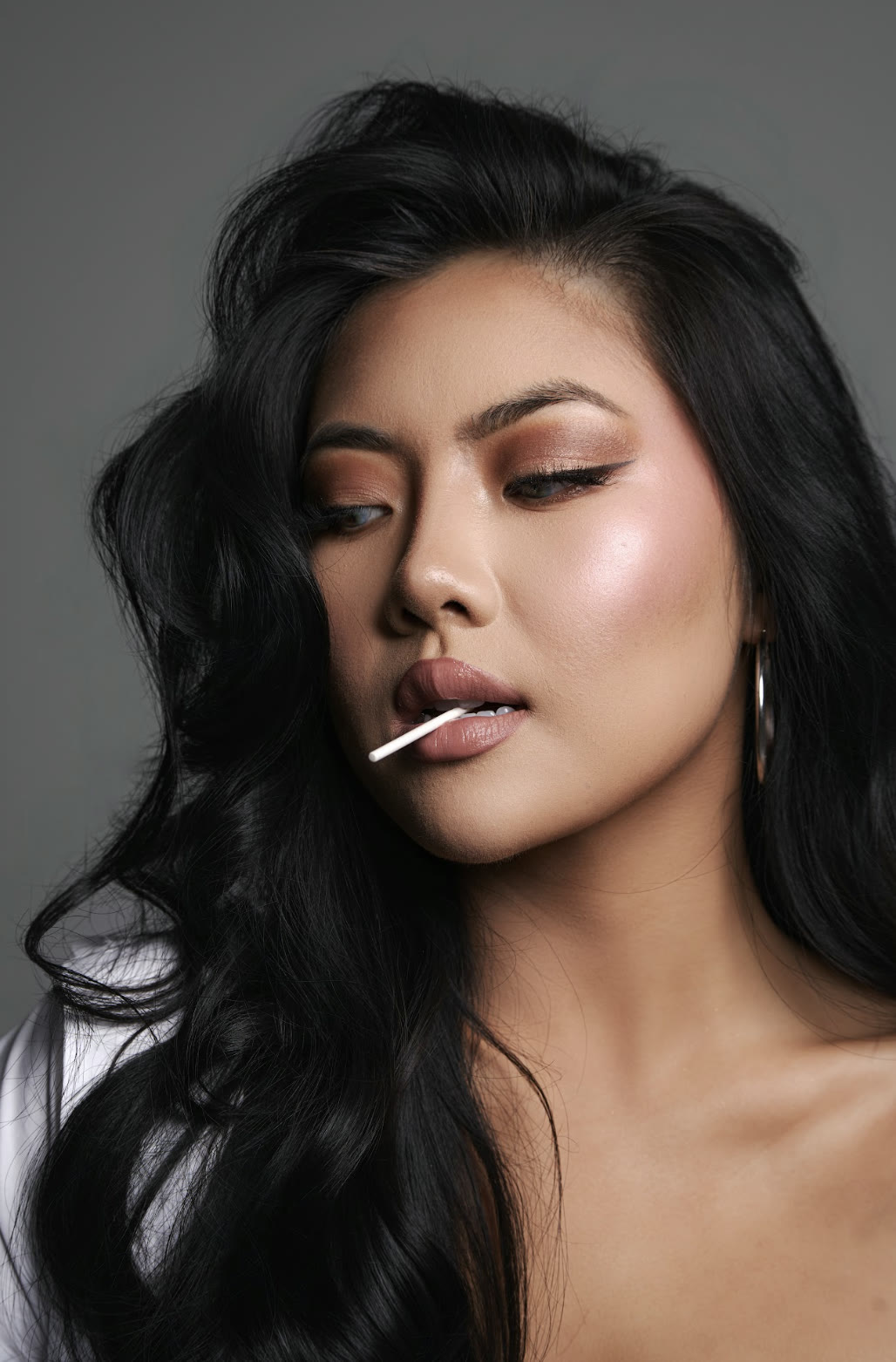 Vivian True with a lollipop, studio close-up portrait